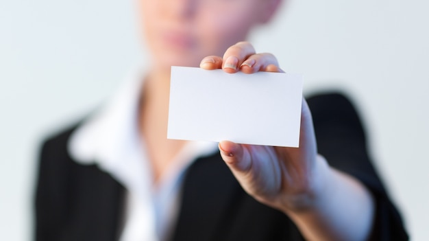 Business woman holding out a business card