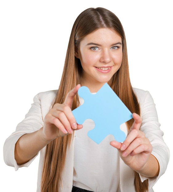 Business woman holding puzzle piece