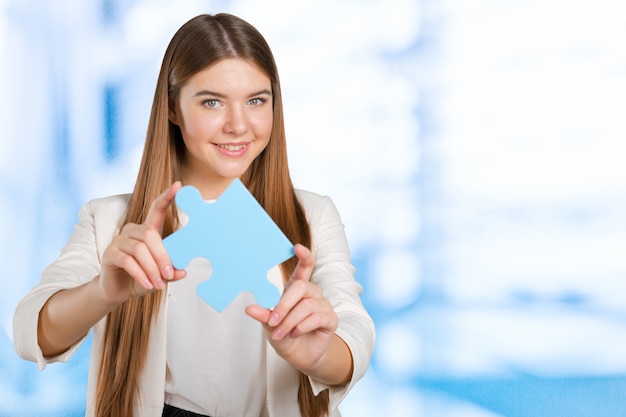 Business woman holding  puzzle piece