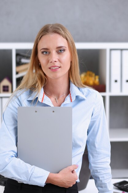 Business woman holding a writing tablet in the office