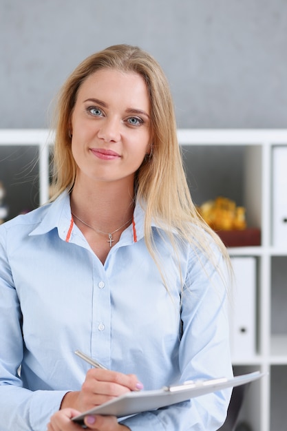 Business woman holding a writing tablet