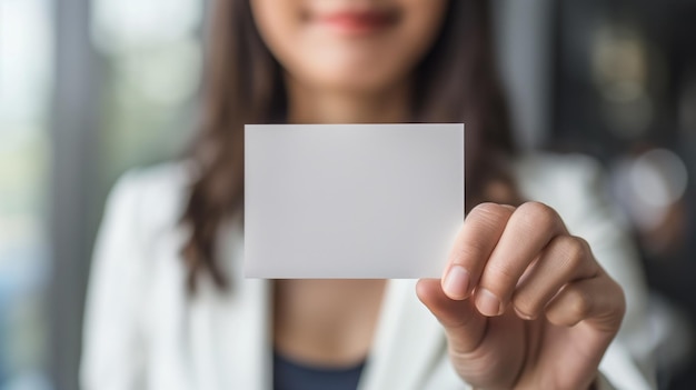 Business woman holds a clean business card in her hands closeup