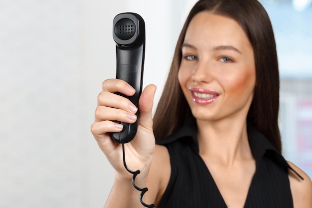 Business woman is holding the IT Phone handset