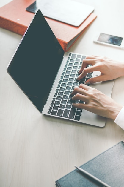 A business woman is opening her computer searching for information about work.