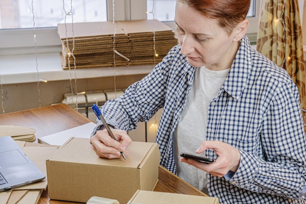 Business woman is packing orders of her online store Small business work from home