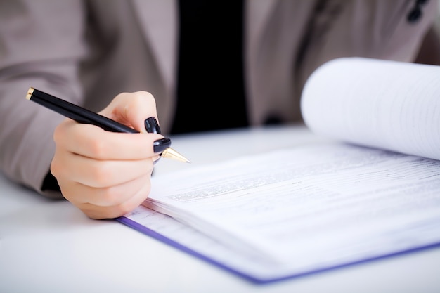 Business woman is signing a contract, business contract details