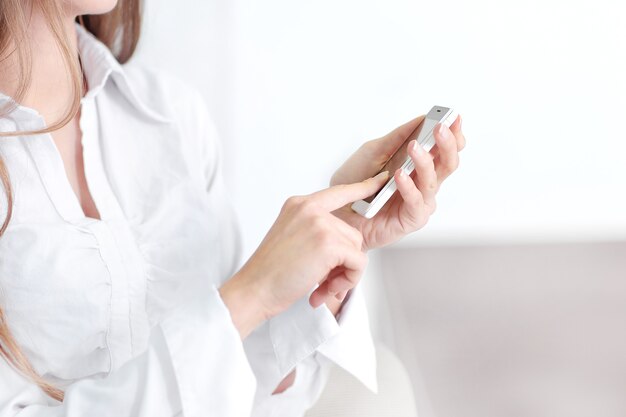 business woman is typing SMS on mobile phone.