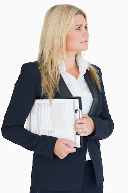 Business woman looking away in the white background with a clipboard