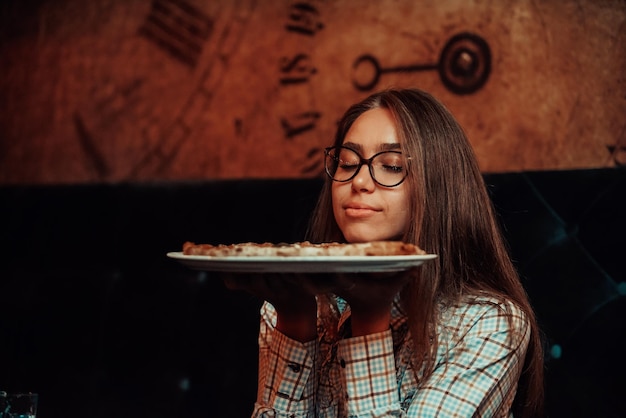 A business woman on a lunch break eating pizza in a modern restaurant Selective Focus