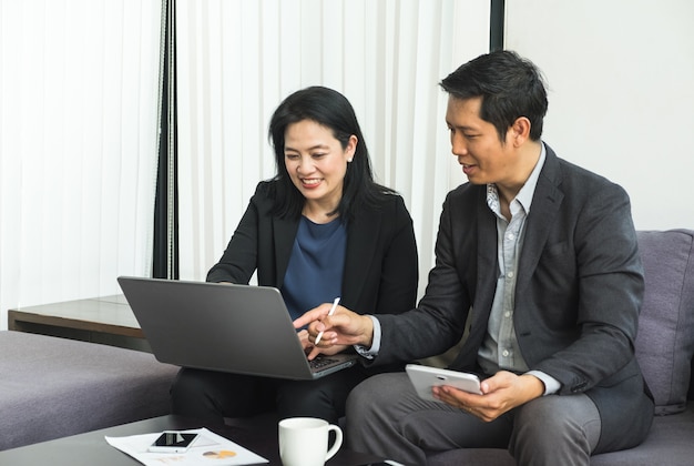 Business woman and man using tablet