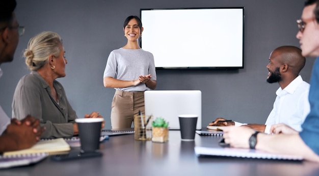 Photo business woman meeting and presentation with mockup screen for team strategy or project management at office female person coach or mentor with smile in staff training on mock up at the workplace