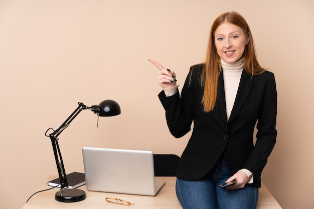 Business woman in a office pointing finger to the side