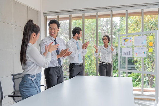 Business woman presentation plan marketing or project in future\
in meeting room and team applauded