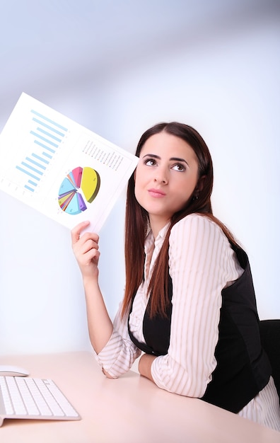 Business woman reading and checking business graph.