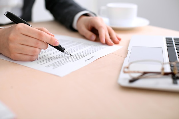 Business woman ready to sign a contract while sitting at the table