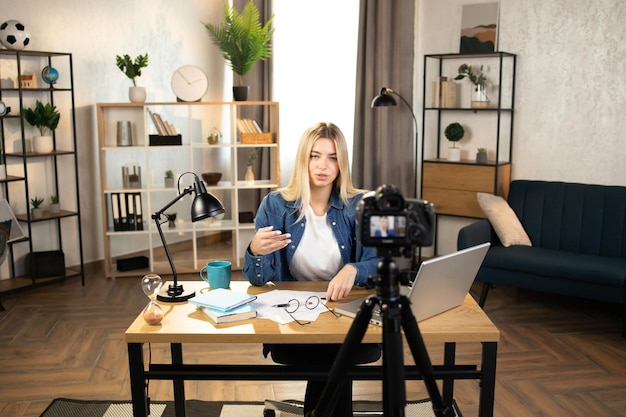 Business woman recording masterclass on video camera