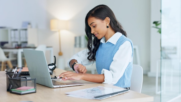 Business woman relaxing after finally finishing a deadline and working on a laptop alone at work Pleased black female corporate professional done with a project and sending emails