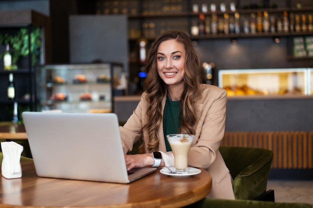 Business Woman Restaurant Owner Use Laptop In Hands Dressed Elegant Pantsuit Sitting Table In Restaurant With Bar Counter Background Caucasian Female Business Person Indoor