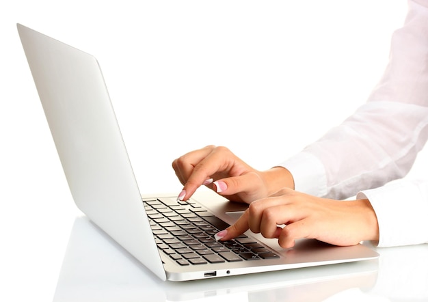Photo business woman's hands typing on laptop computer on white background closeup