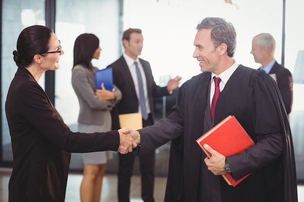business woman shaking hands with lawyer