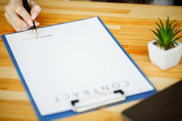 Business woman signing a contract or document