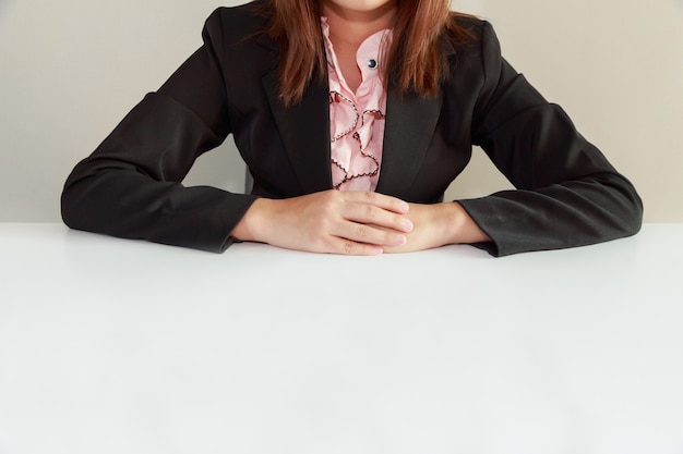 Business woman sitting at desk and waiting for interviewer - interview concept.