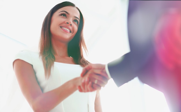 Business woman smiling and making a deal in her office