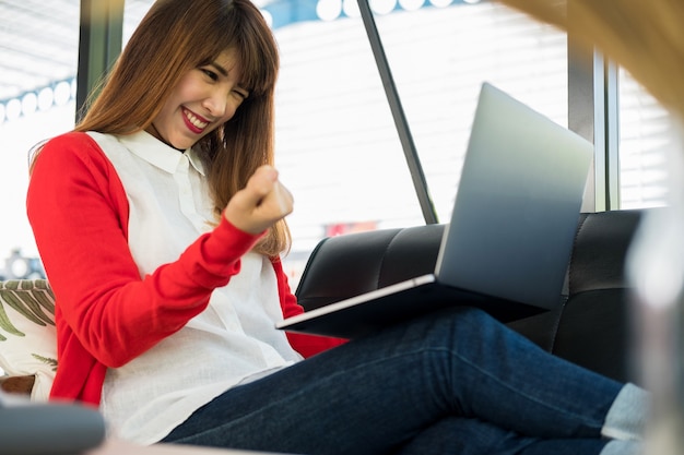 business woman smiling with arms up celebrating for success work at the office