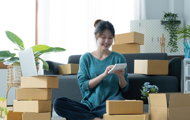 Business woman start up small business entrepreneur sme success
freelance woman working at home with online parcel delivery sme and
packaging deliveryconcept