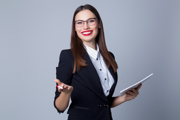 Business woman in studio on gray background