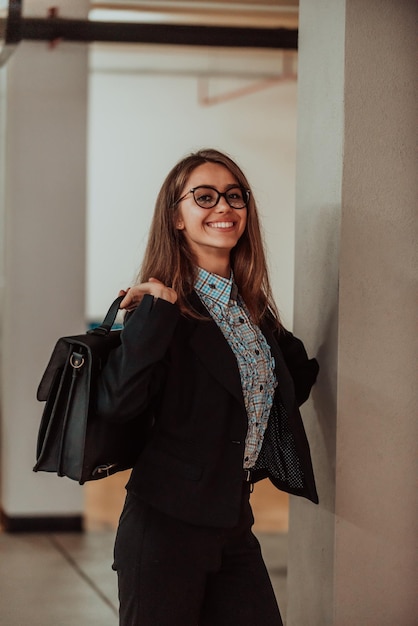 A business woman in a suit with a briefcase in her hand goes to work Selective focus Business concept