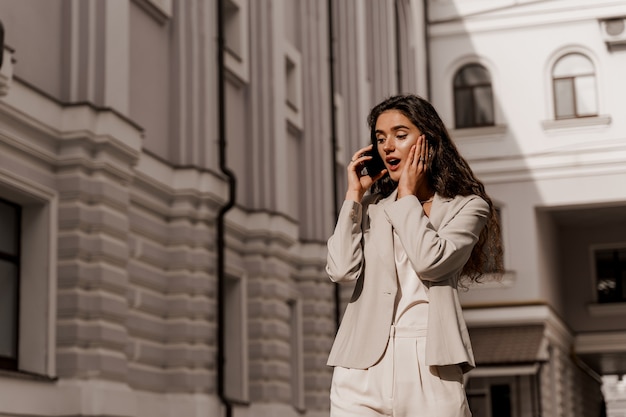 Business woman talking by phone in the city