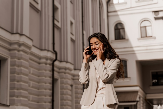 Business woman talking by phone in the city