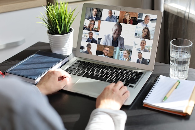 Business woman talking to her colleagues in video conference