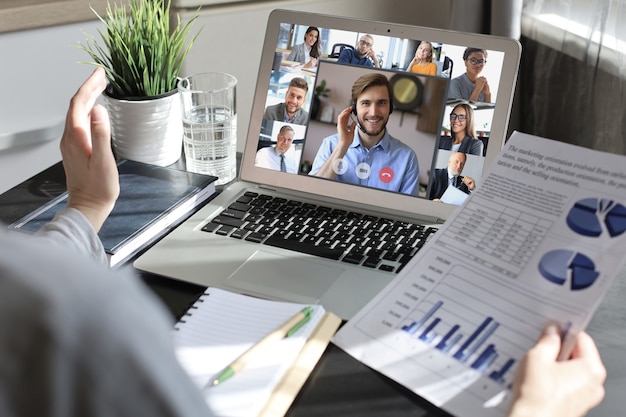 Business woman talking to her colleagues in video conference