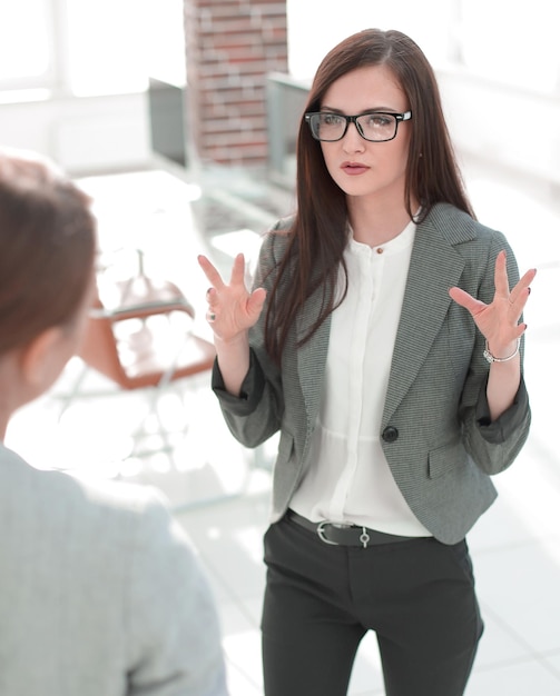 Business woman talking to an office worker