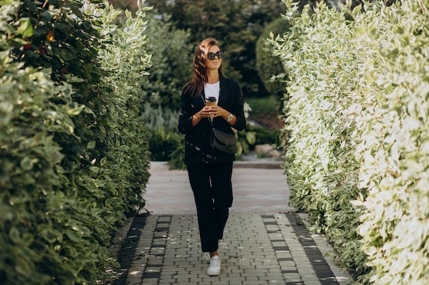 Business woman talking on the phone in park