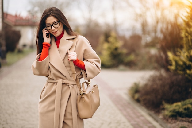 Business woman talking on the phone in the street