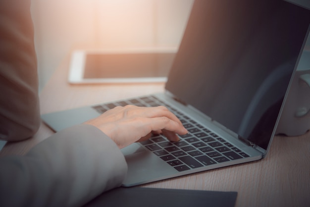 Business woman use laptop in office. Vintage tone