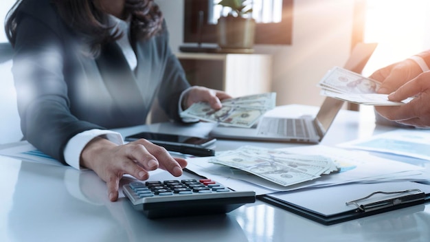 Business woman using a calculator to calculating and analyzing data Investment consultant