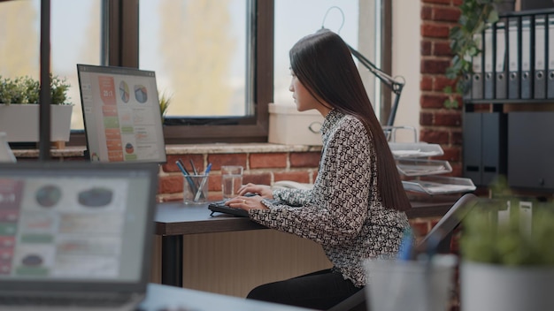 Business woman using computer to plan charts analysis in startup office. Entrepreneur working on marketing project and strategy to help with company development and growth. Management job