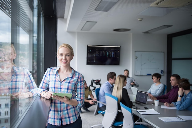 Business Woman Using Digital Tablet in corporate office by window