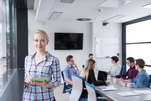 Business Woman Using Digital Tablet in corporate office by window