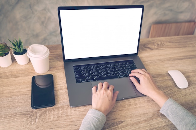 Business woman using laptop computer do online activity on wood table at home office.