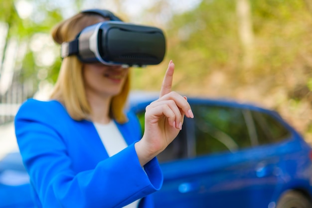 Business woman using vr goggles moving her head touching the simulation screen with blue car on the