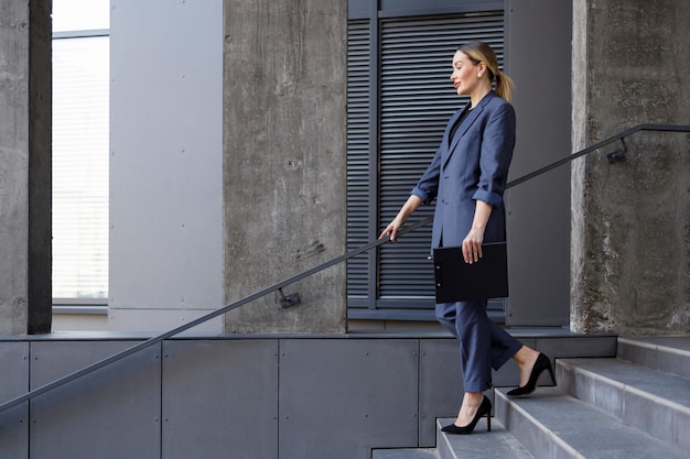 Business woman walking down the stairs outdoors