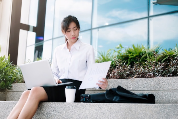 Business woman walking drinking coffee.