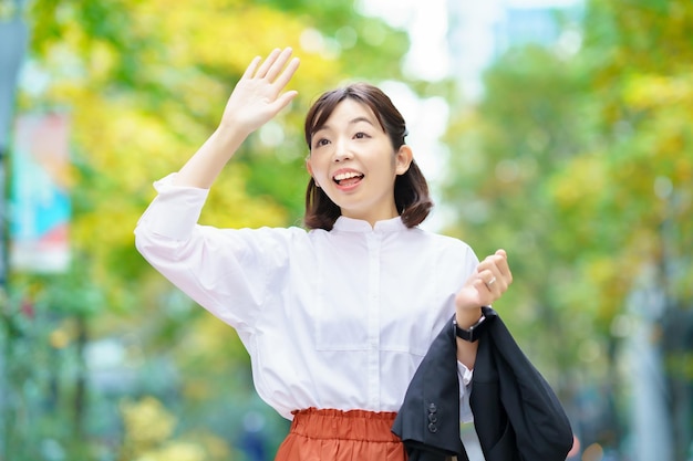 Business woman waving her hands on the street