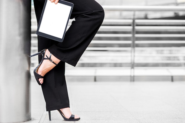 Business woman wear high heel and hold tablet