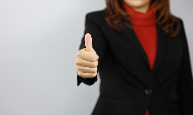 Business woman wearing black and red business suit uniform with confident while showing thumb up   